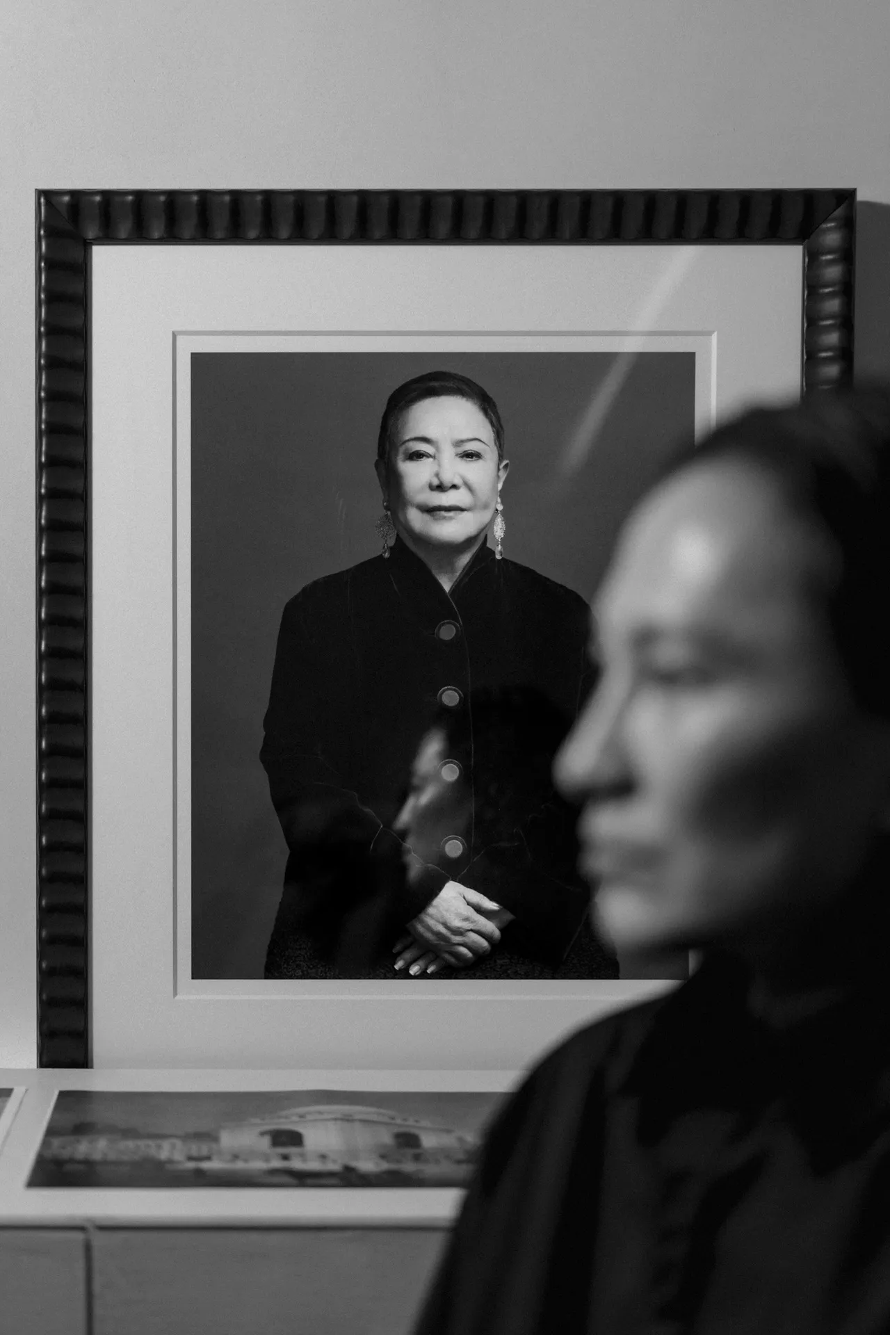 Wang’s Manhattan headquarters, which Tashjian likened to a medieval fortress, is located in Seaport and marked by eight imposing black flags bearing his name. His minimalist office sits in the middle of it all. Behind his stark desk, a portrait of the matriarch herself, Alexander’s mother Ying Wang.
