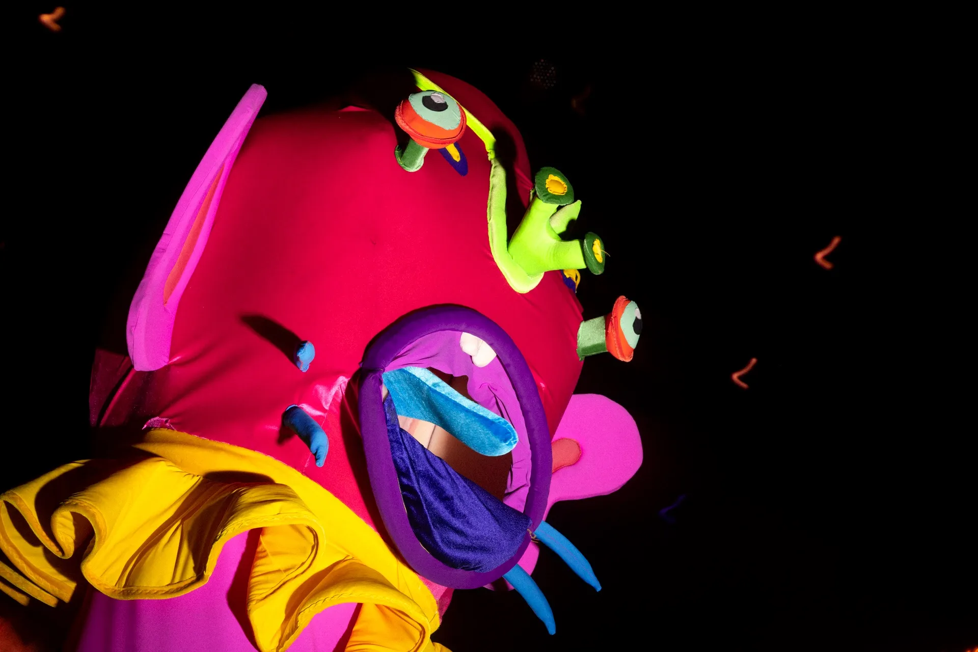 A tall pink monster puppeted by an immersive visual artist, IVA, at Luna Luna.